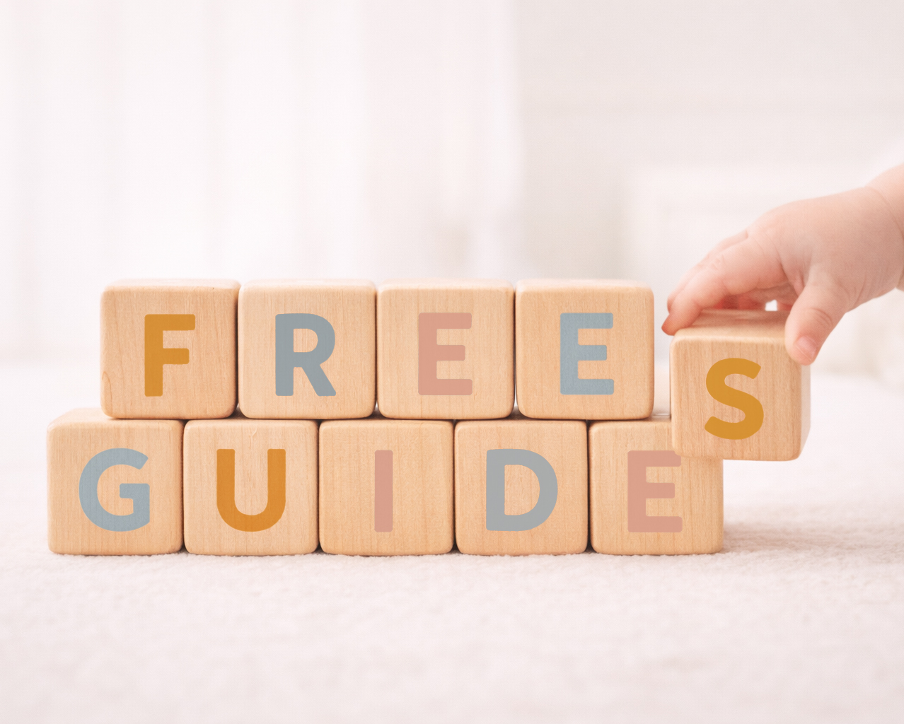 Wooden blocks spelling ‘Free Guides’ for sleep and potty support from Lullabies & Leaps